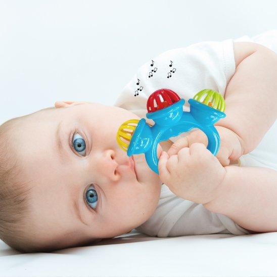 Nourrisson allongé attrapant un hochet bébé d’éveil sensoriel